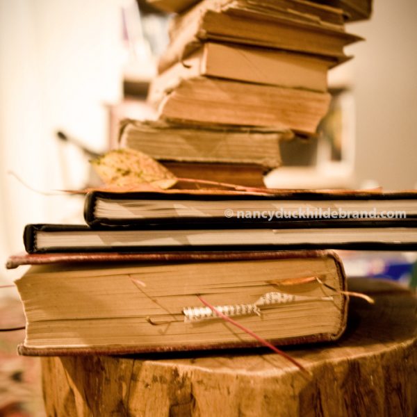      Pressing leaves under a stack of books